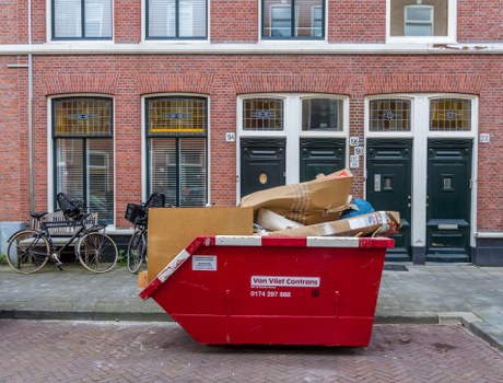 Workers performing rubbish clearance during house clearance