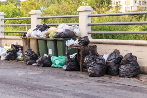 Residents disposing of household waste through council rubbish collection